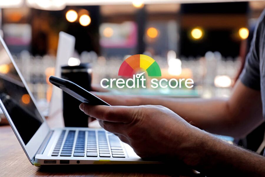 A man checks his phone with a credit score diagram hovering above it.