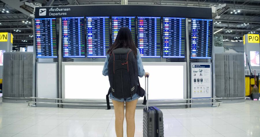 Asian woman passenger wearing blue jeans.