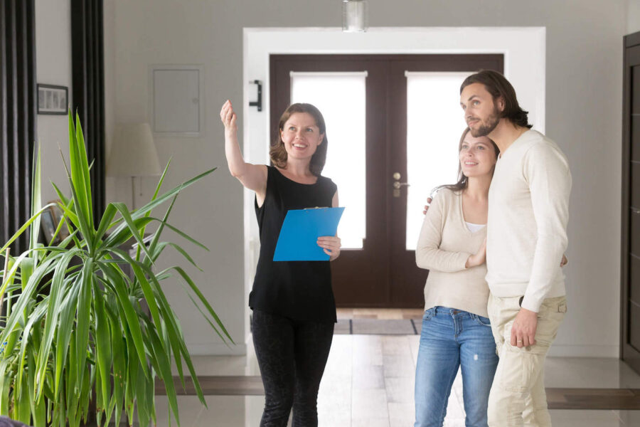 A couple listen to a realtor who is showing them a new home.