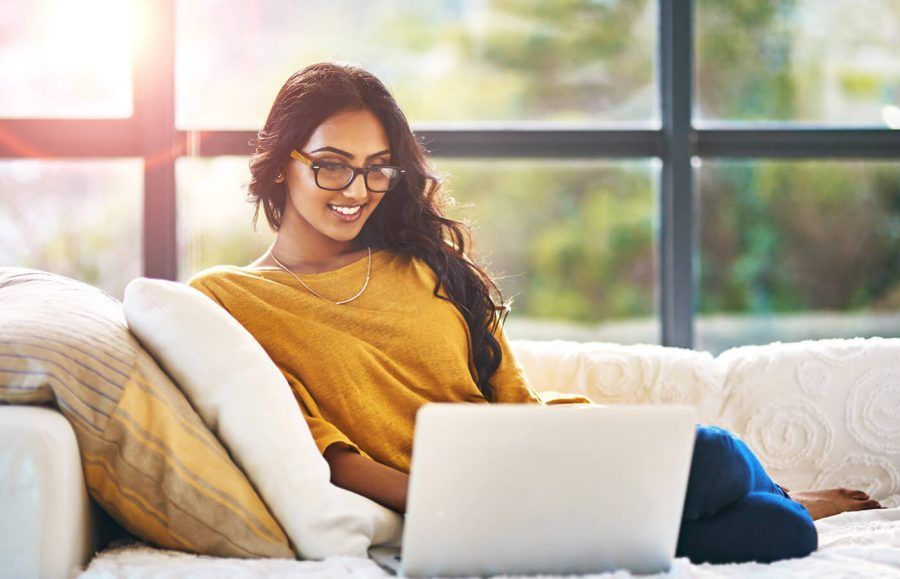 woman sitting on couch with laptop searching how to buy series i bonds
