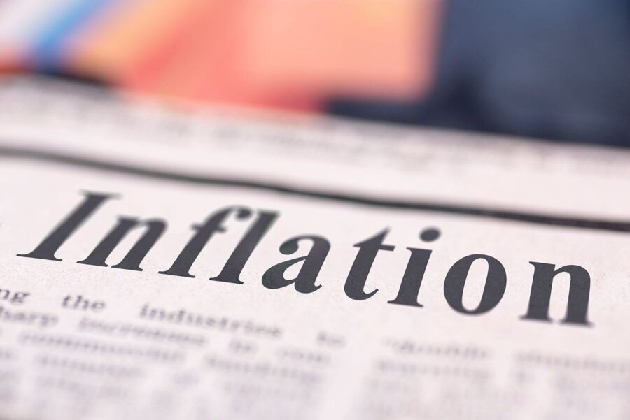 A newspaper article has inflation as a headline with bolded black ink.