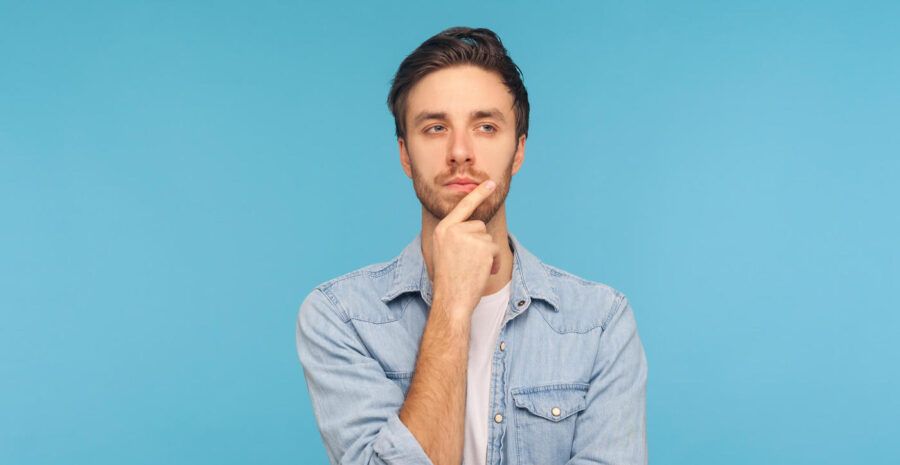 man in thinking pose against blue background