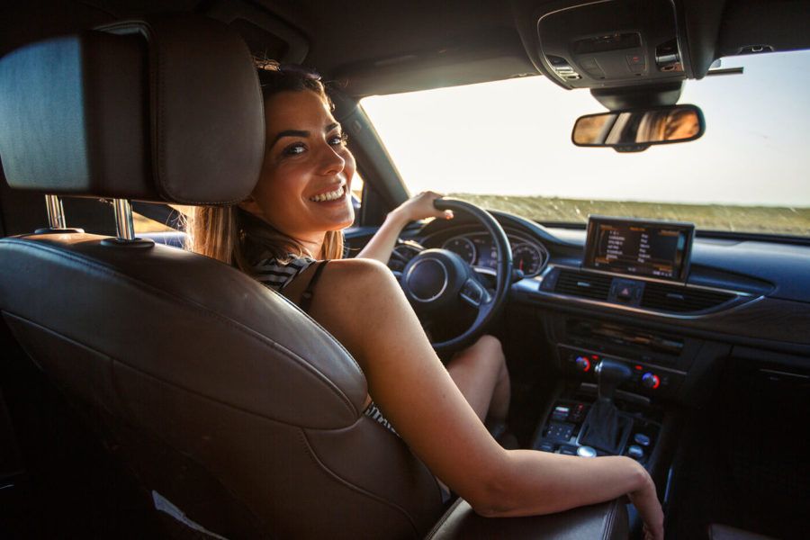 Smiling young woman going on a road trip