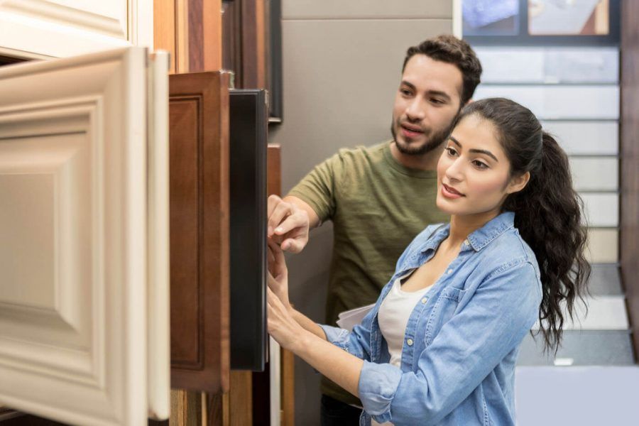 Couple look at cabinet samples in hardware store