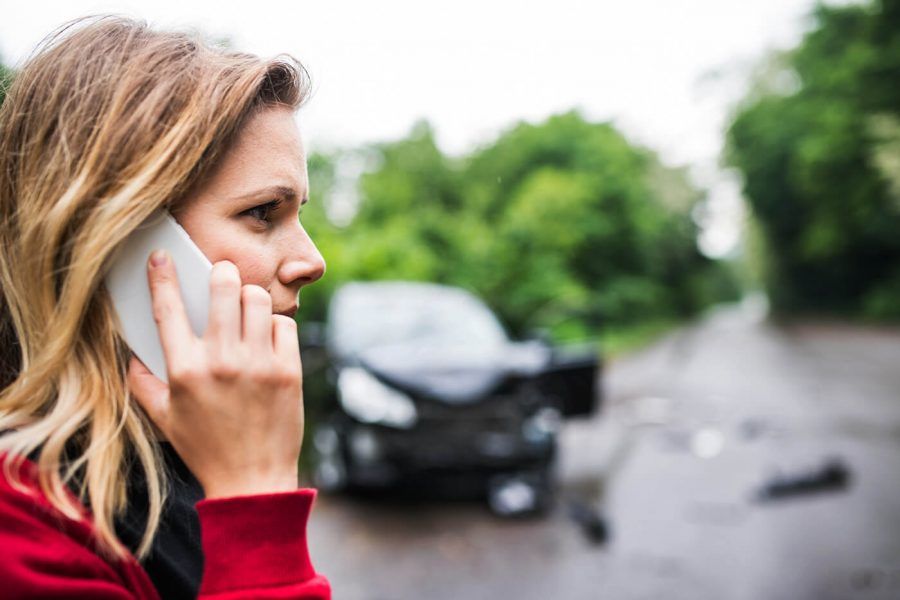 woman on phone in a car accident