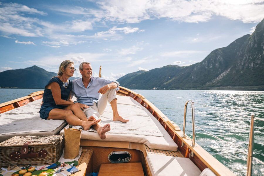 couple enjoying the perks of careful wealth management on a private boat