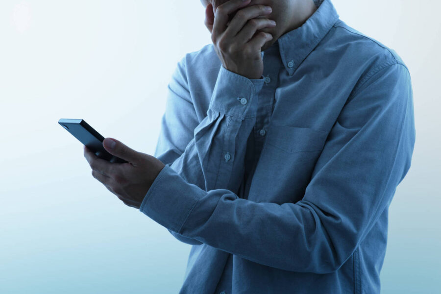 man worried while looking at phone