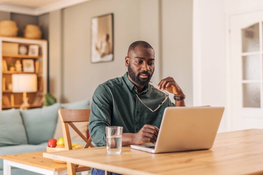 Focused man using his laptop at home
