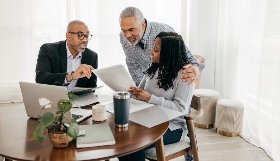 A couple negotiating mortgage rates with a broker