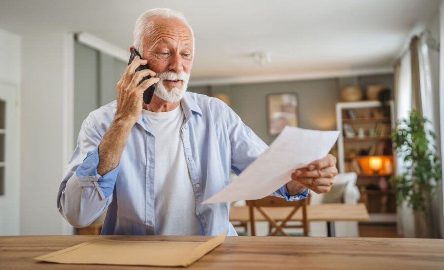 Senior man negotiating his utility bill over the phone