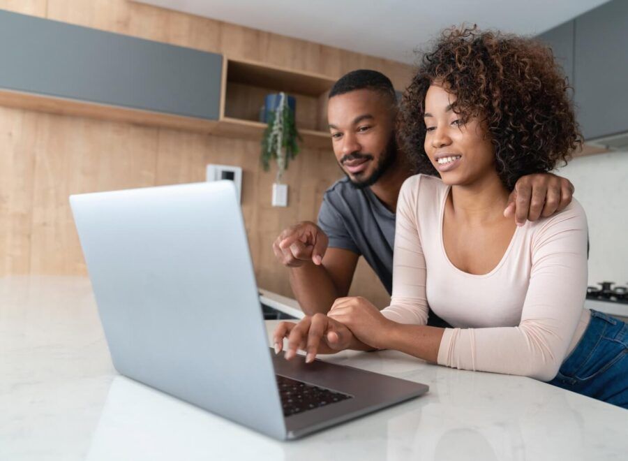 Young couple using a laptop together at home