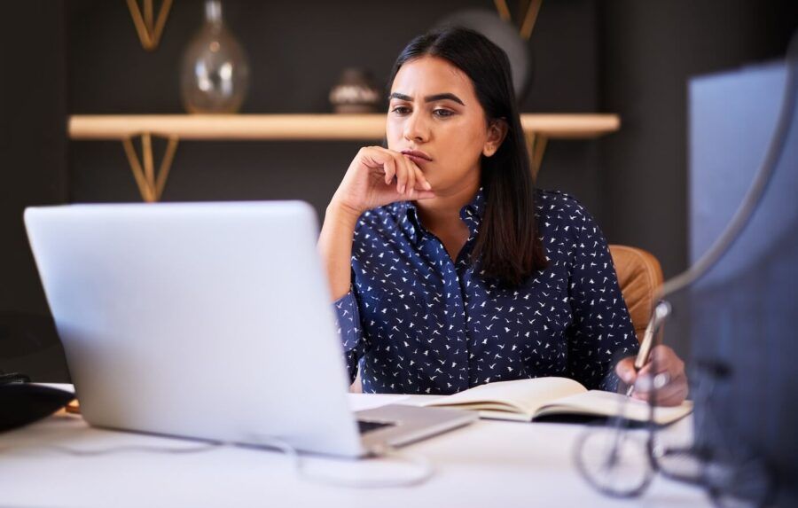 Focused woman compares car insurance policies on her laptop