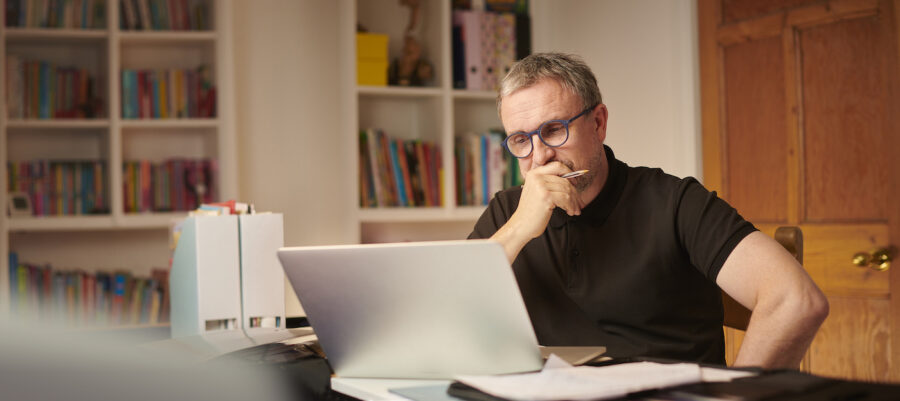 mature man working on finances, rethinking frugal moves