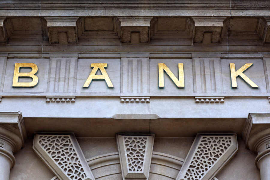concrete building with gold letters spelling bank