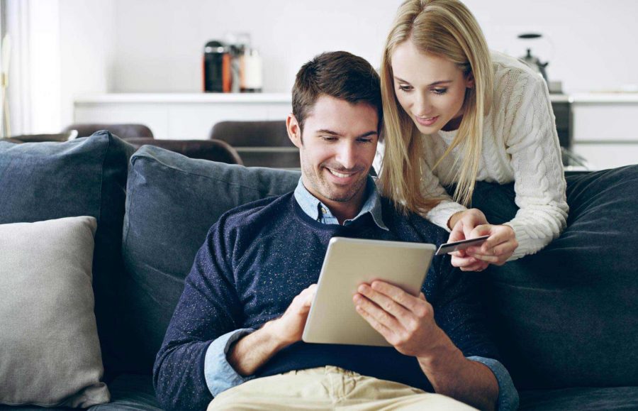 Couple Reviewing Report on Sofa