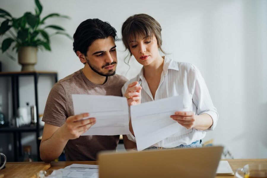 Focused young couple reviewing their credit card statements