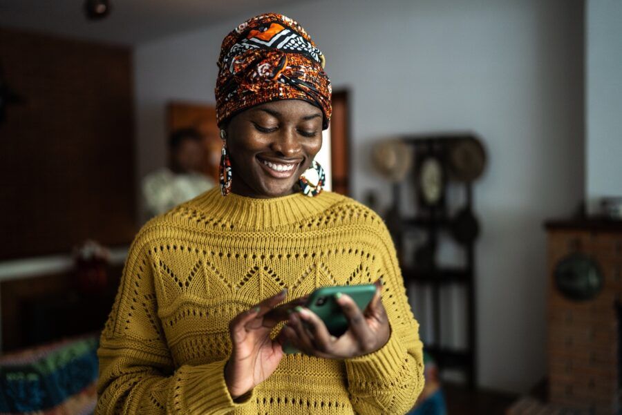 Young woman using her mobile phone at home