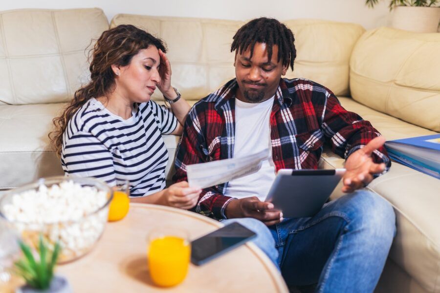 A couple at home analyzing their taxes.
