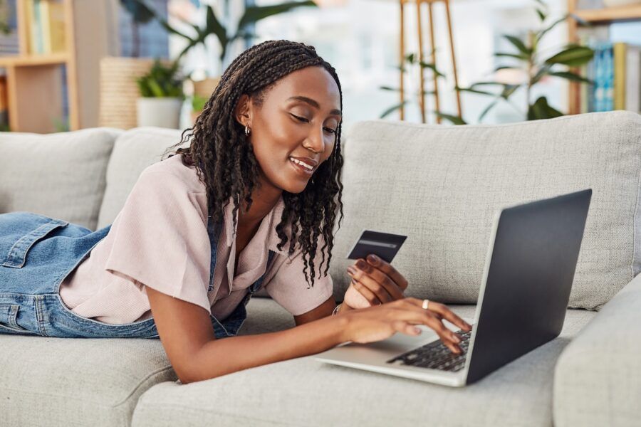 A woman using a debit card online.
