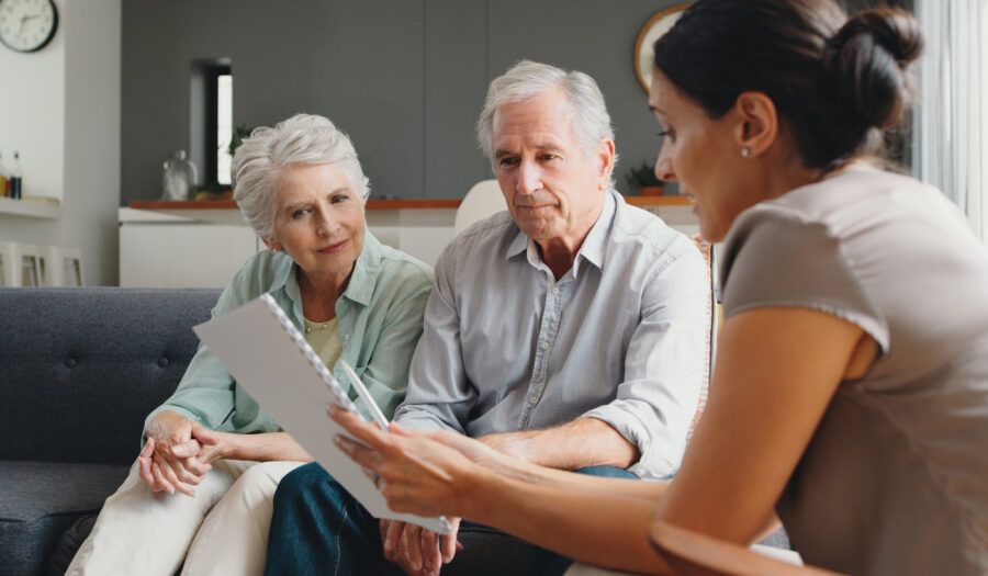 Senior couple consulting with a financial advisor with a QRDO agreement