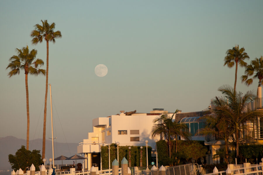 This is a picture of a full moon rising over a house in Coronado Bay in Southern California.