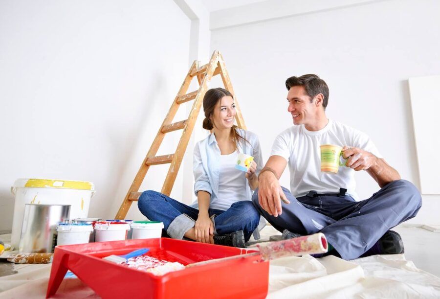 Young couple taking a coffee break during a home renovation
