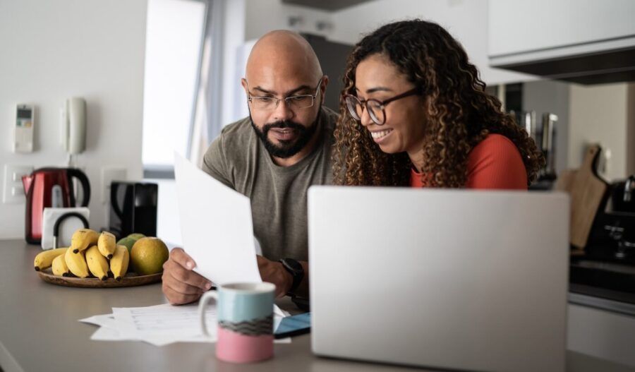 Couple reviewing homeowner insurance plans in the kitchen