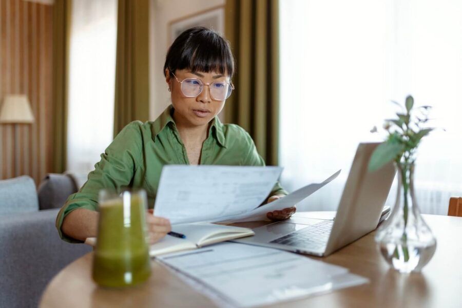 Focused woman filing taxes online at home