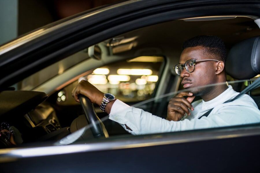Thoughtful young man driving a car
