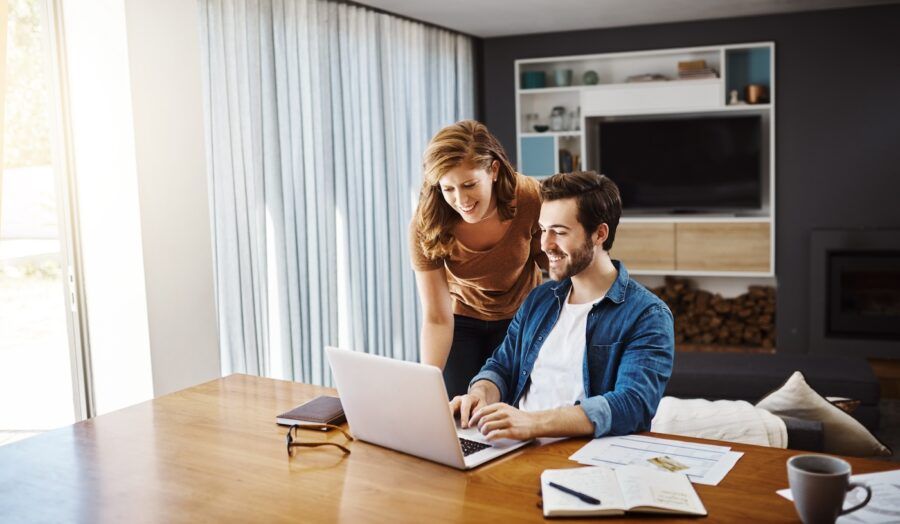 Shot of a young couple doing some financial planning together on a laptop at home.