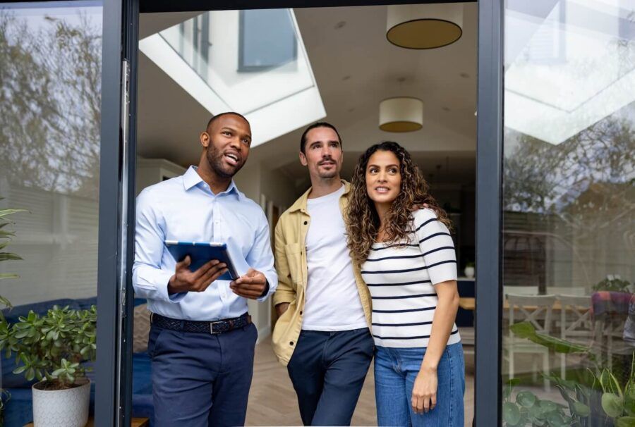 A real estate agent showing a house to the prospective buyers