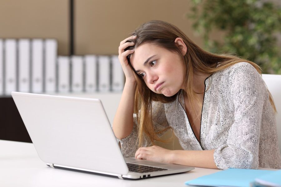Frustrated woman working online at home