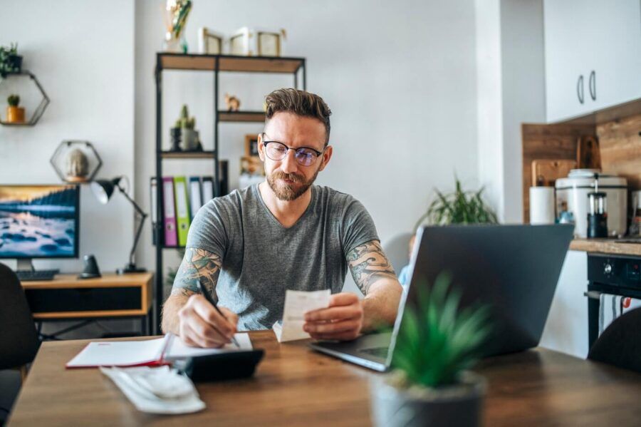 Man calculating taxes in the living room