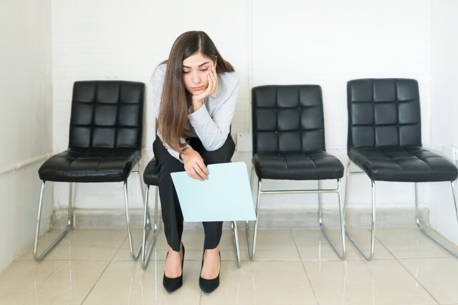 Jobless woman contemplates her financial plans in an office