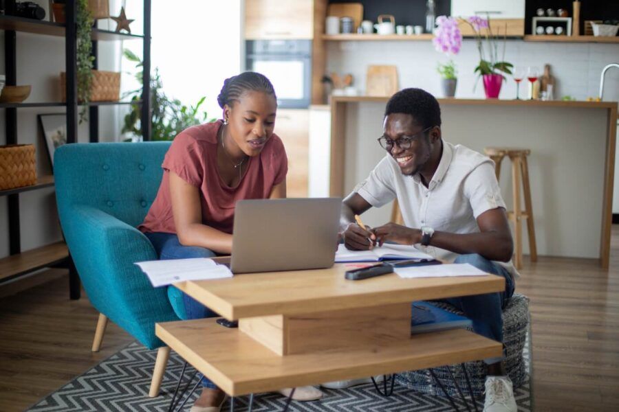 Young couple using laptop and and planning their finances at home