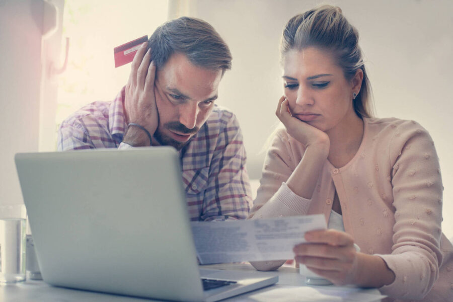 Man and woman couple deciding whether to pay debt or save for down payment.
