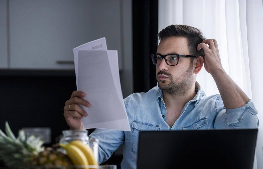 Man Reviewing Payments at Home