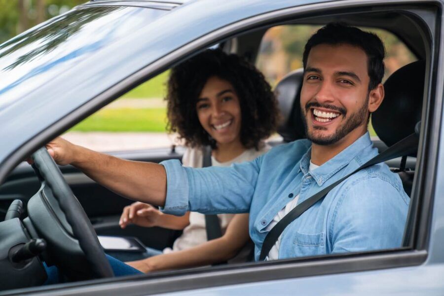 Happy couple driving a car