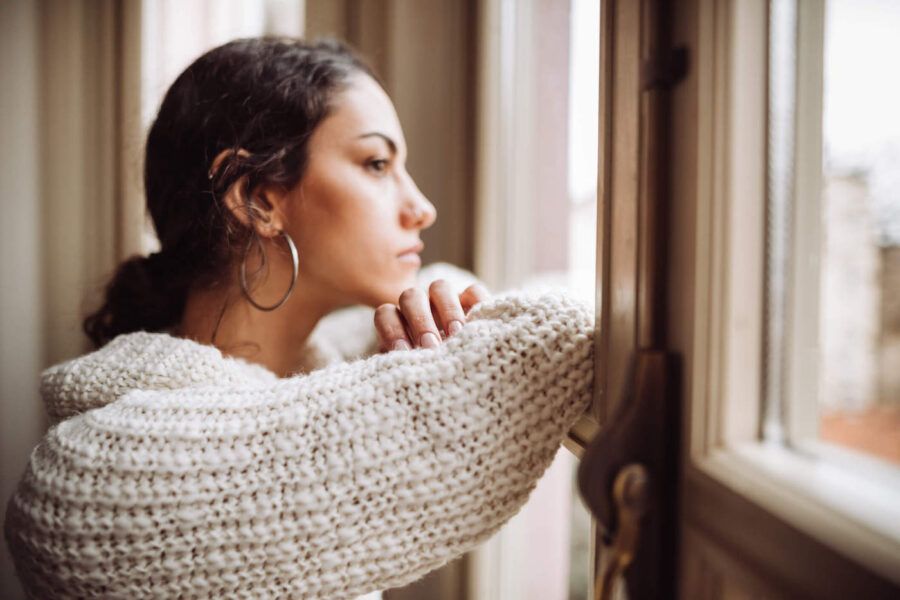 Pensive woman in front of the window.