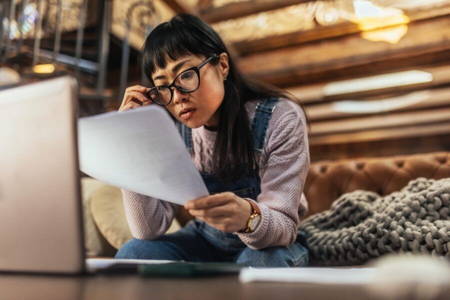 Woman looking worried while reading her credit statement