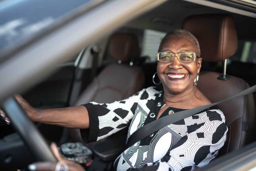 Smiling senior women driving a car