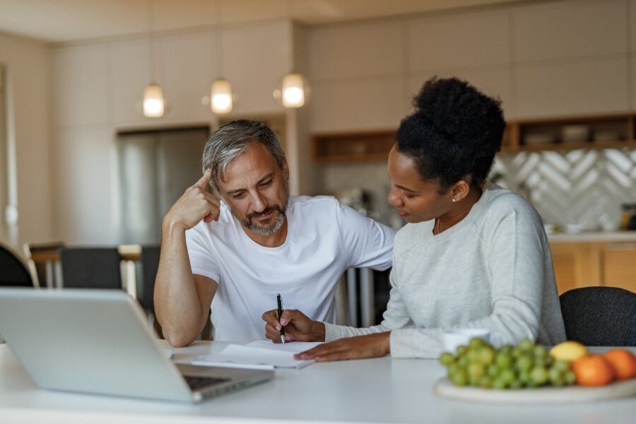 A couple doing financial planning at home.