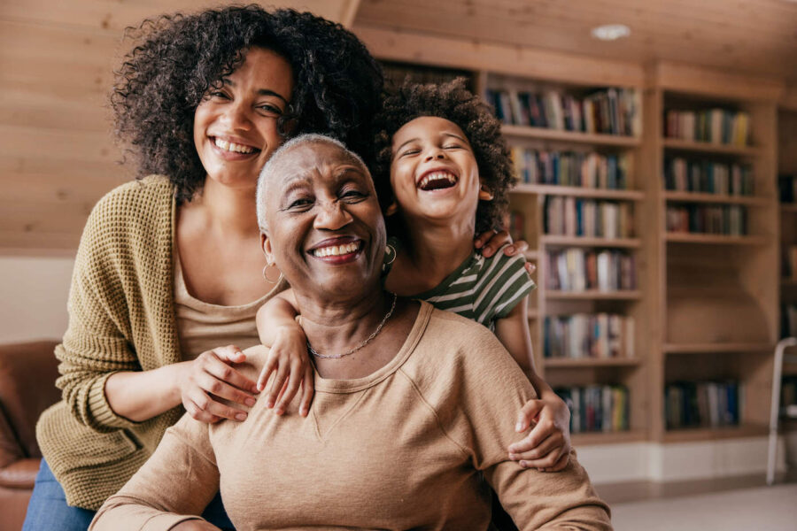 Three generations of women smiling.