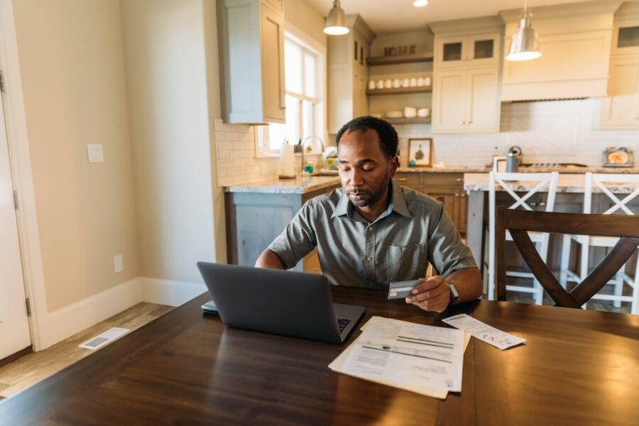 Focused man filing taxes at home