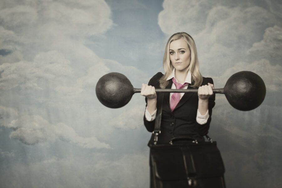 A female finance executive holding a barbell, representing the CD barbell investment strategy.