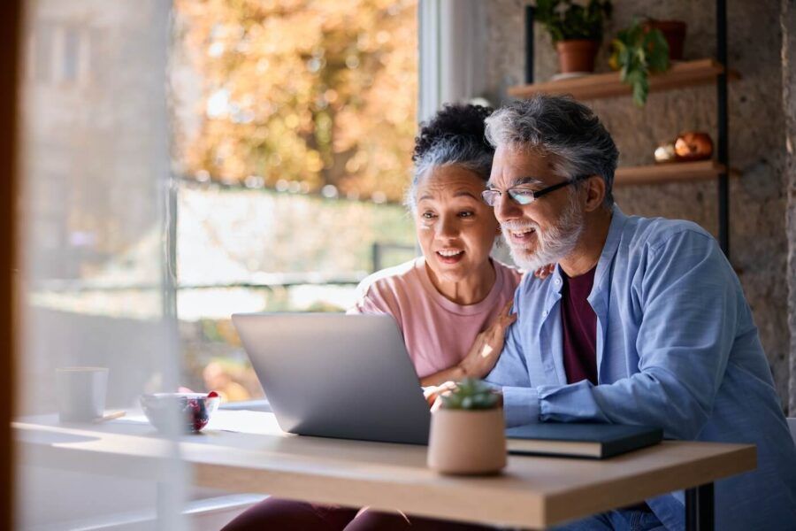 Senior couple using a laptop at home