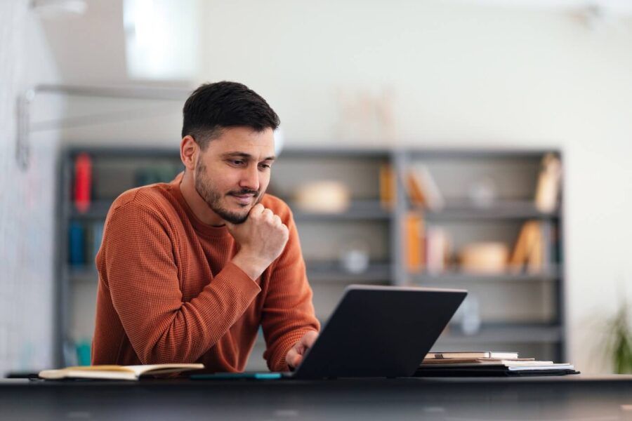 Focused young man using his laptop