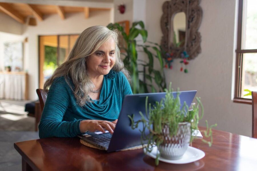 Mature woman using laptop at home