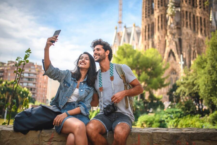 Young couple making a selfie in front of the Sagrada Familia