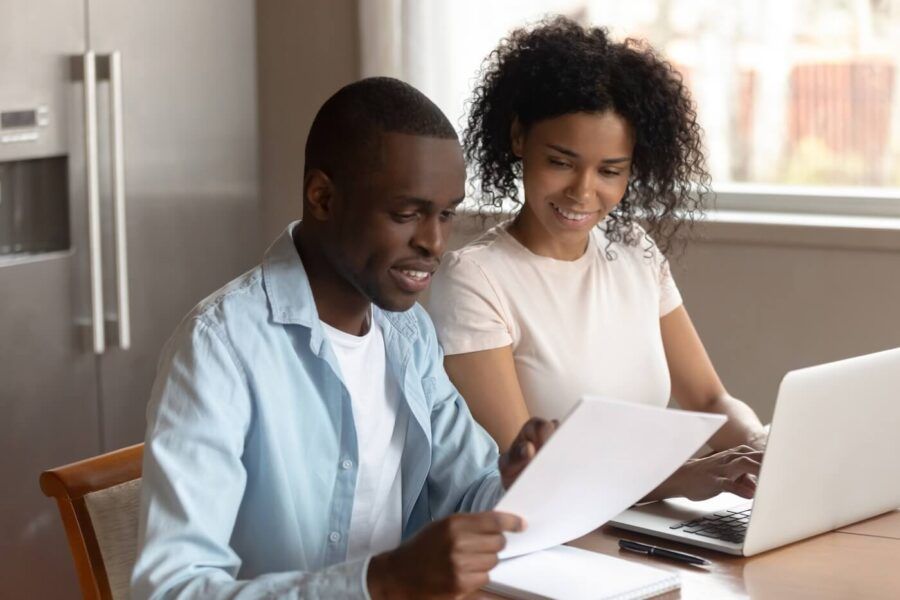 Couple discussing mortgage rates at home while using the laptop